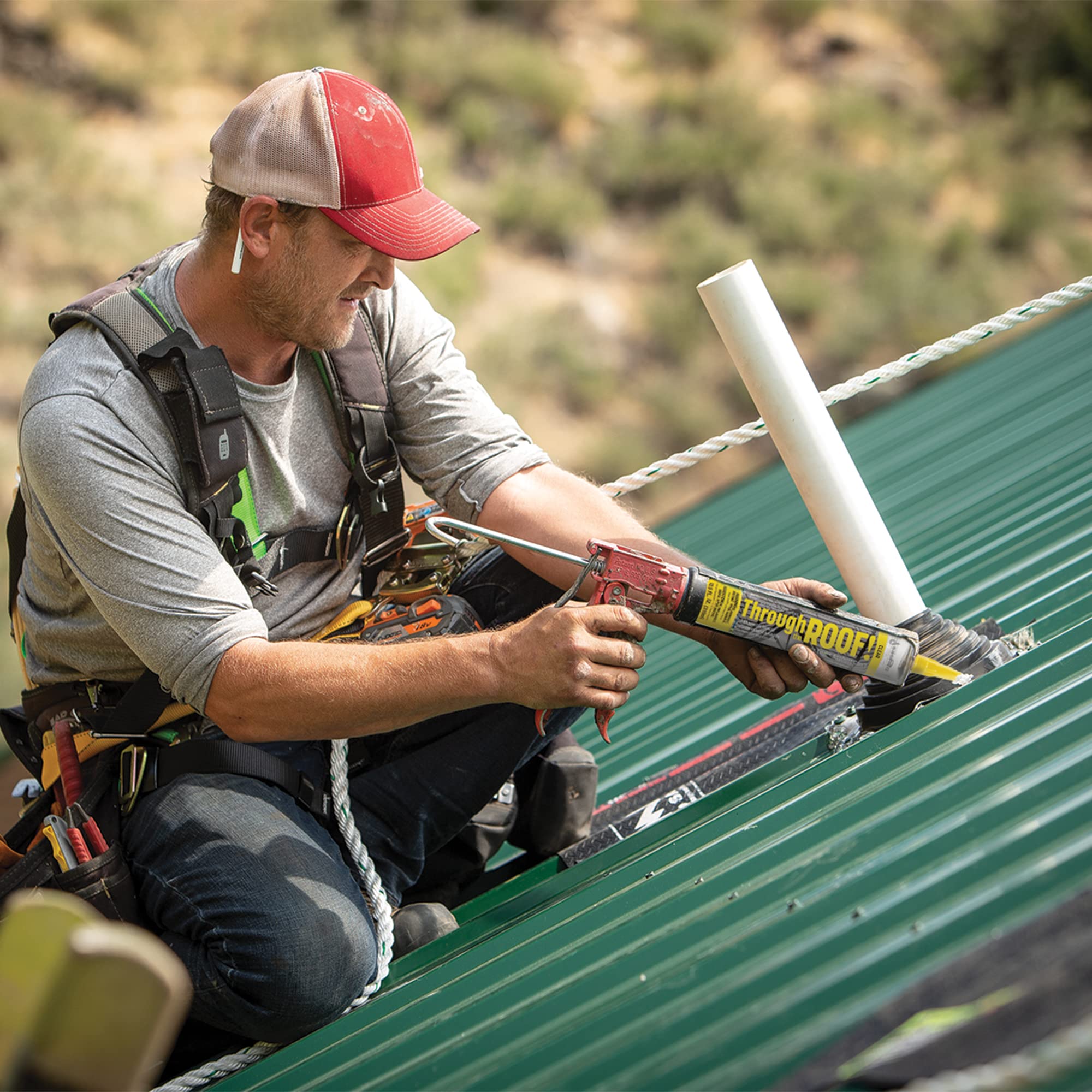 Sashco Through The ROOF being applied to a metal roof seam to stop leaks and prevent runoff