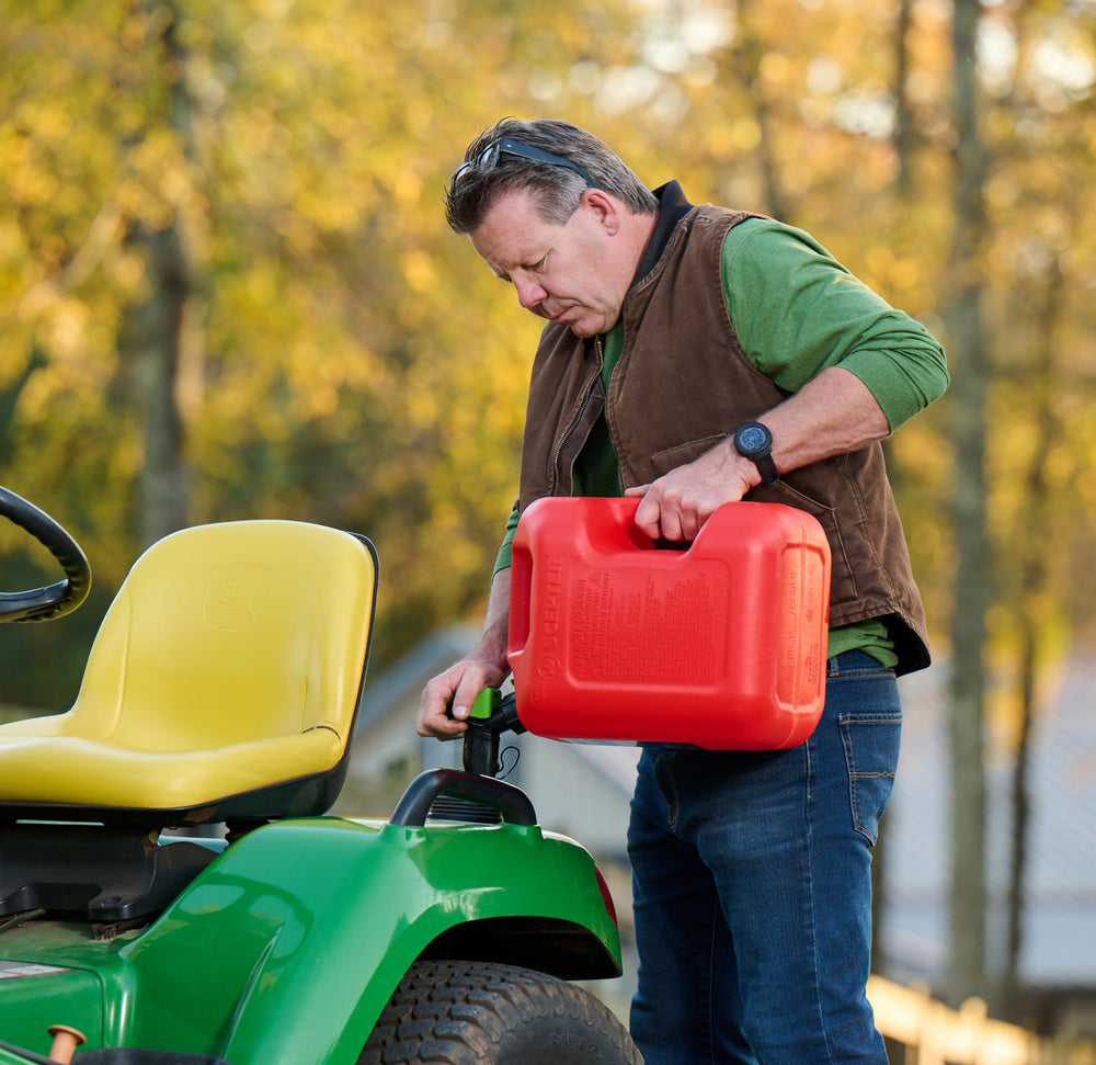Scepter pouring fuel into mower demonstrating clean refill benefit