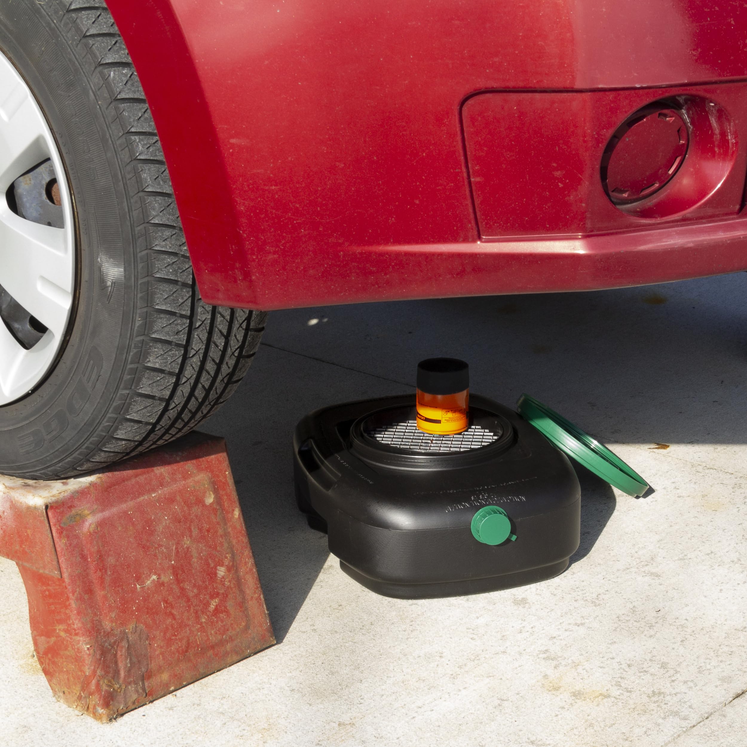 Scepter pan positioned under car catching oil for cleaner workspace