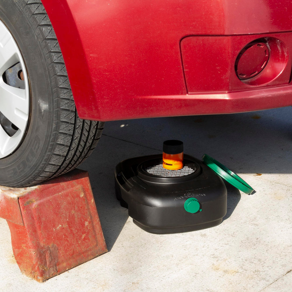 Scepter pan positioned under car catching oil for cleaner workspace