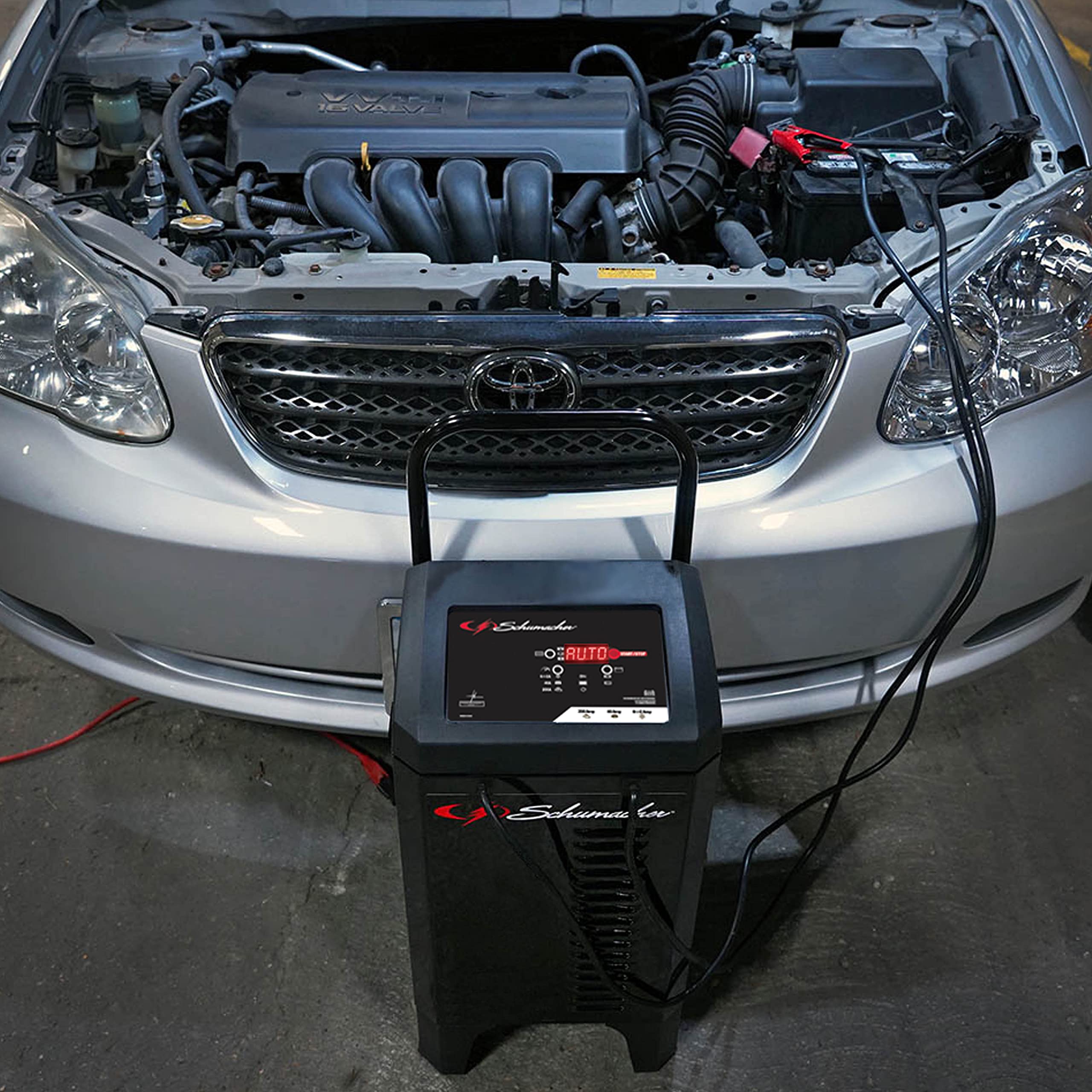 Schumacher Electric SC1353 next to a car showing compact scale and space-saving design