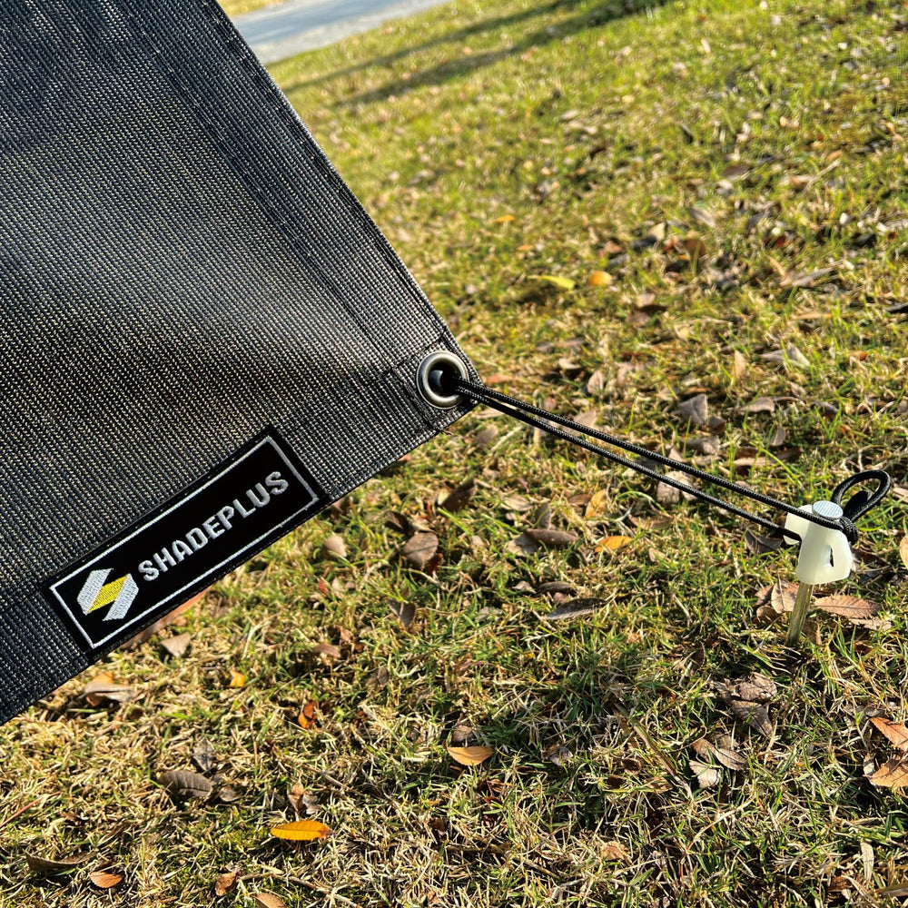 SHADEPLUS staked to ground demonstration showing stable anchoring benefit