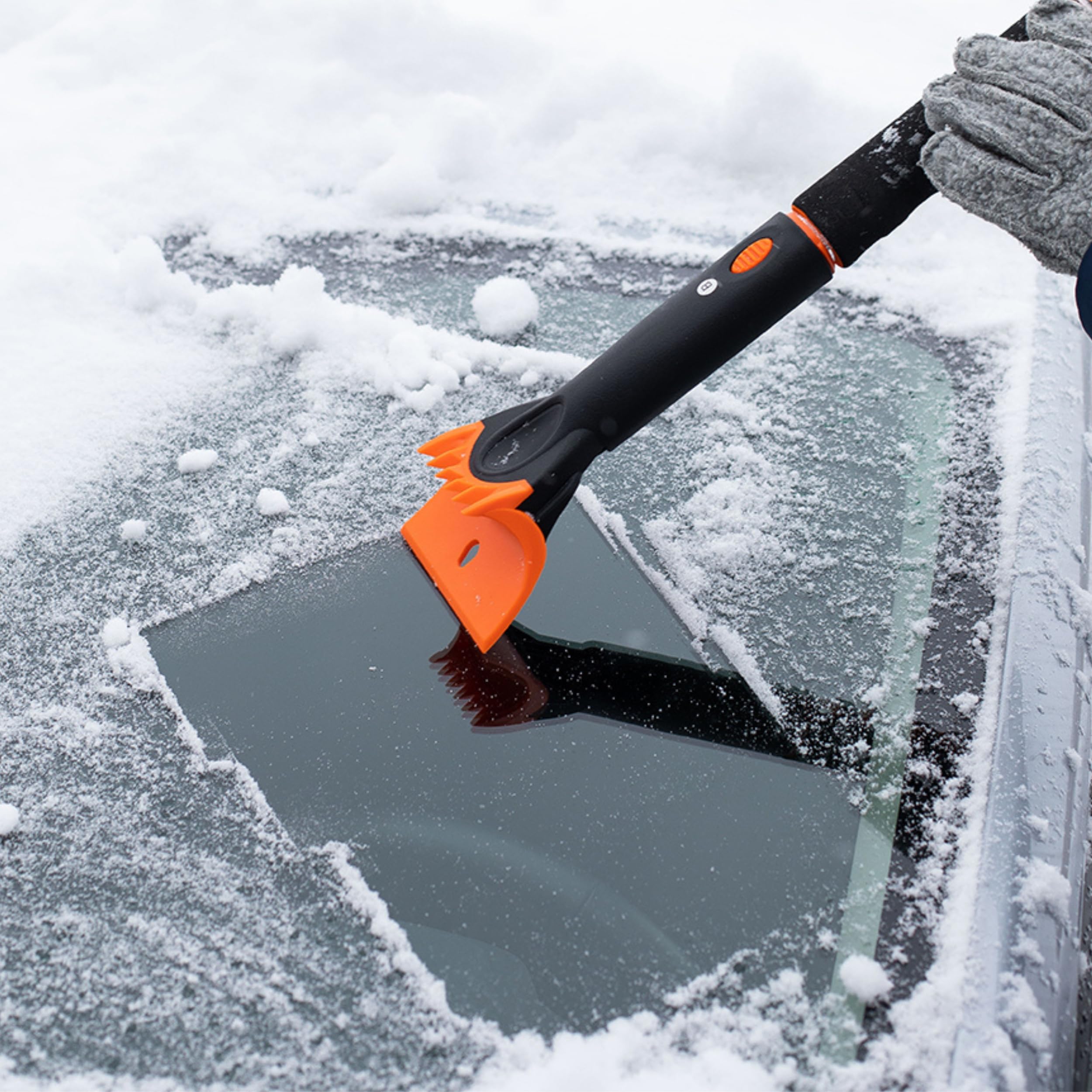Snow MOOver next to a hand for scale showing lightweight, portable design