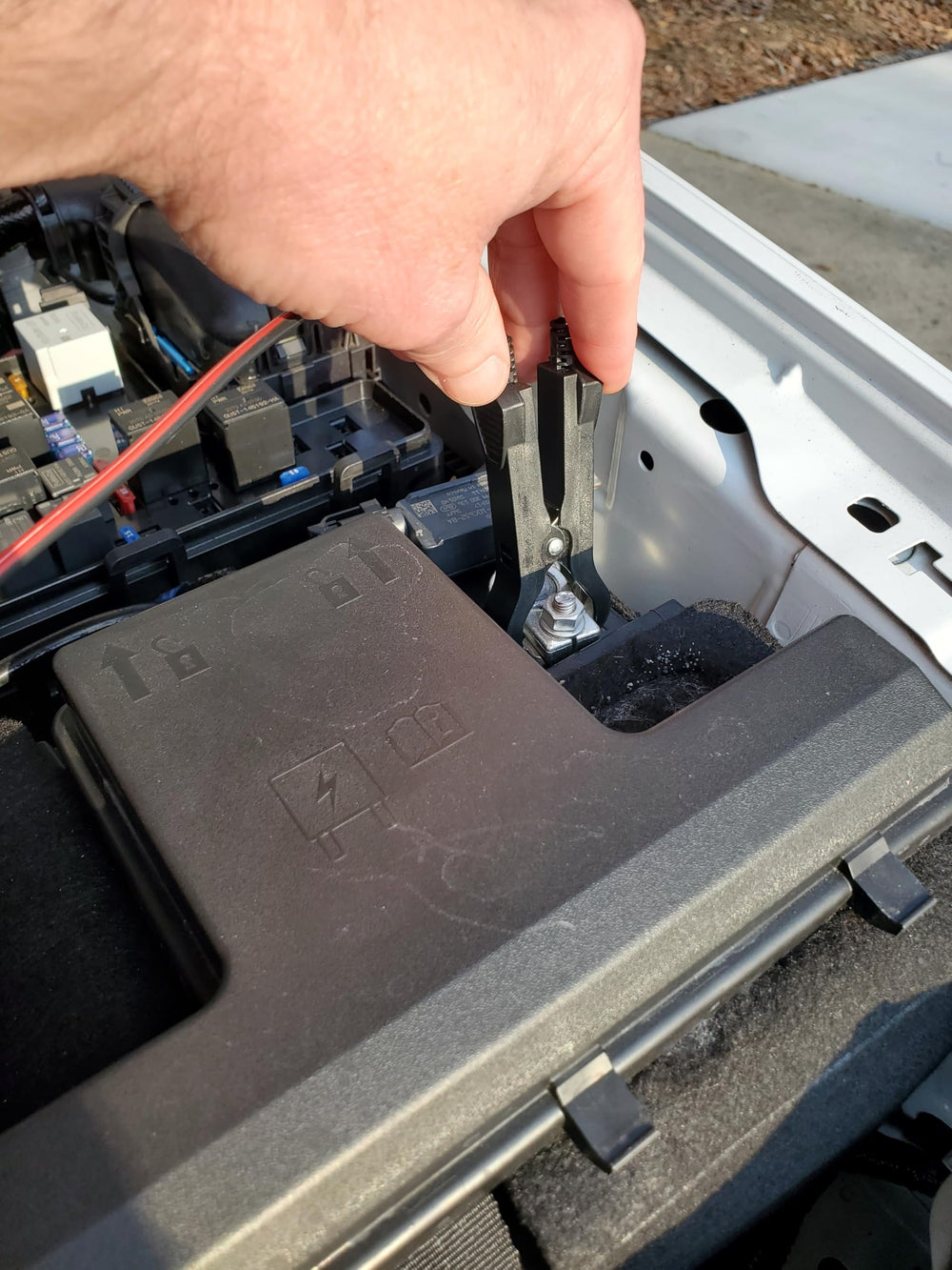 Sound Troubleshooting tester connected to a vehicle relay under the hood for fast diagnostics