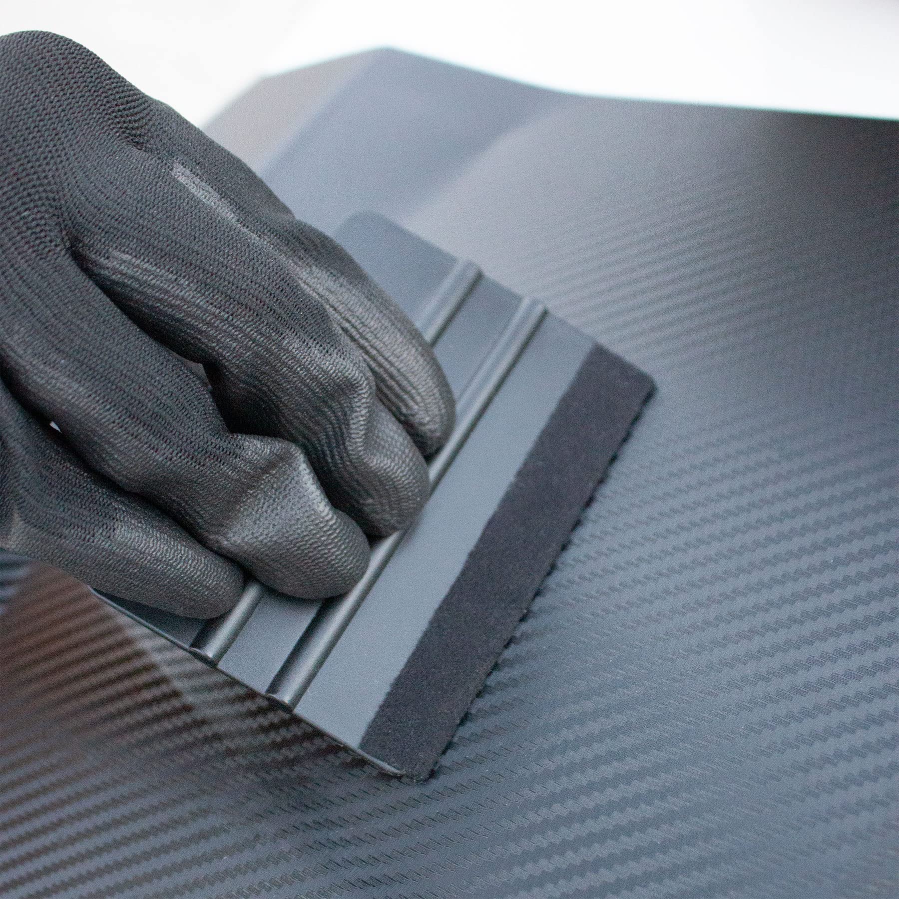 Spanno Tools magnet attached to car door holding vinyl steady and aligning