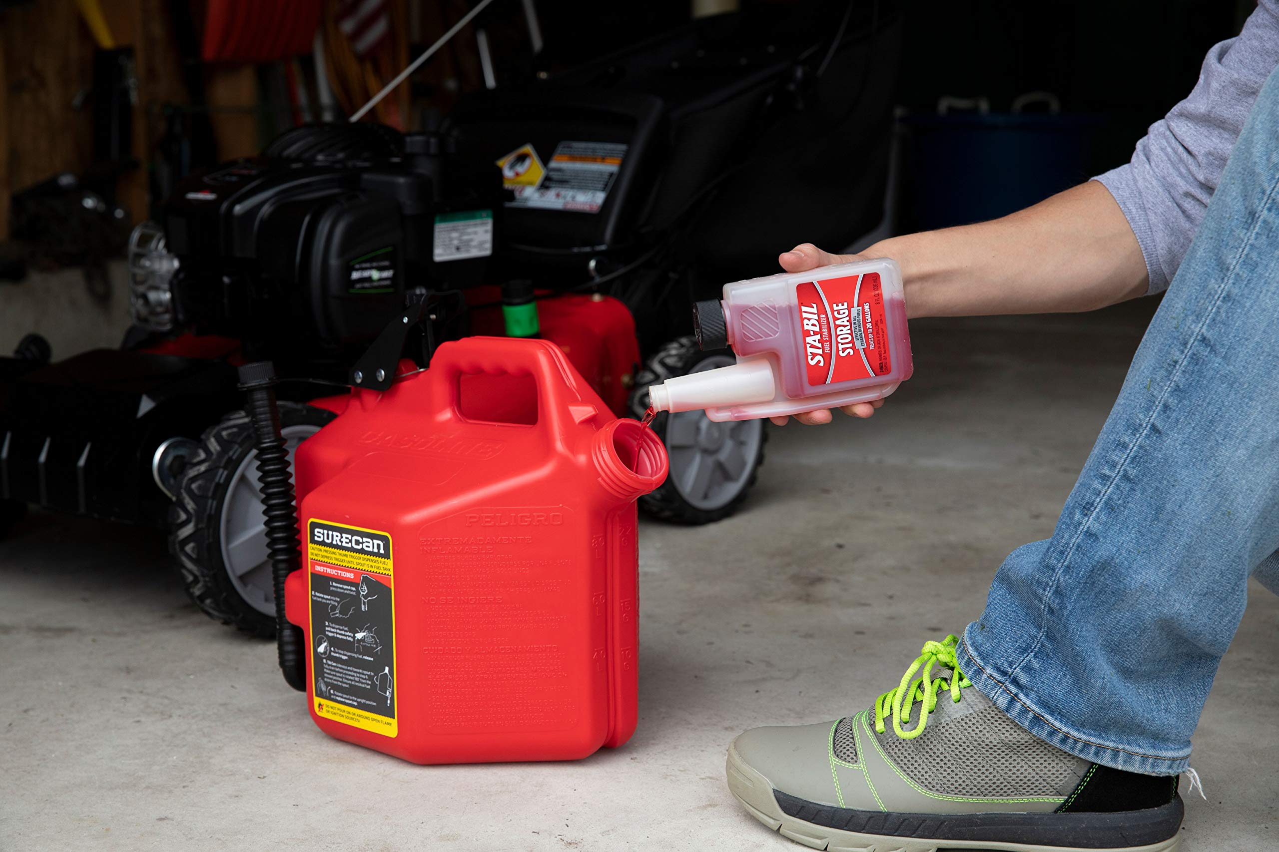 STA-BIL 8 oz bottle next to a lawn mower showing protection for garden equipment