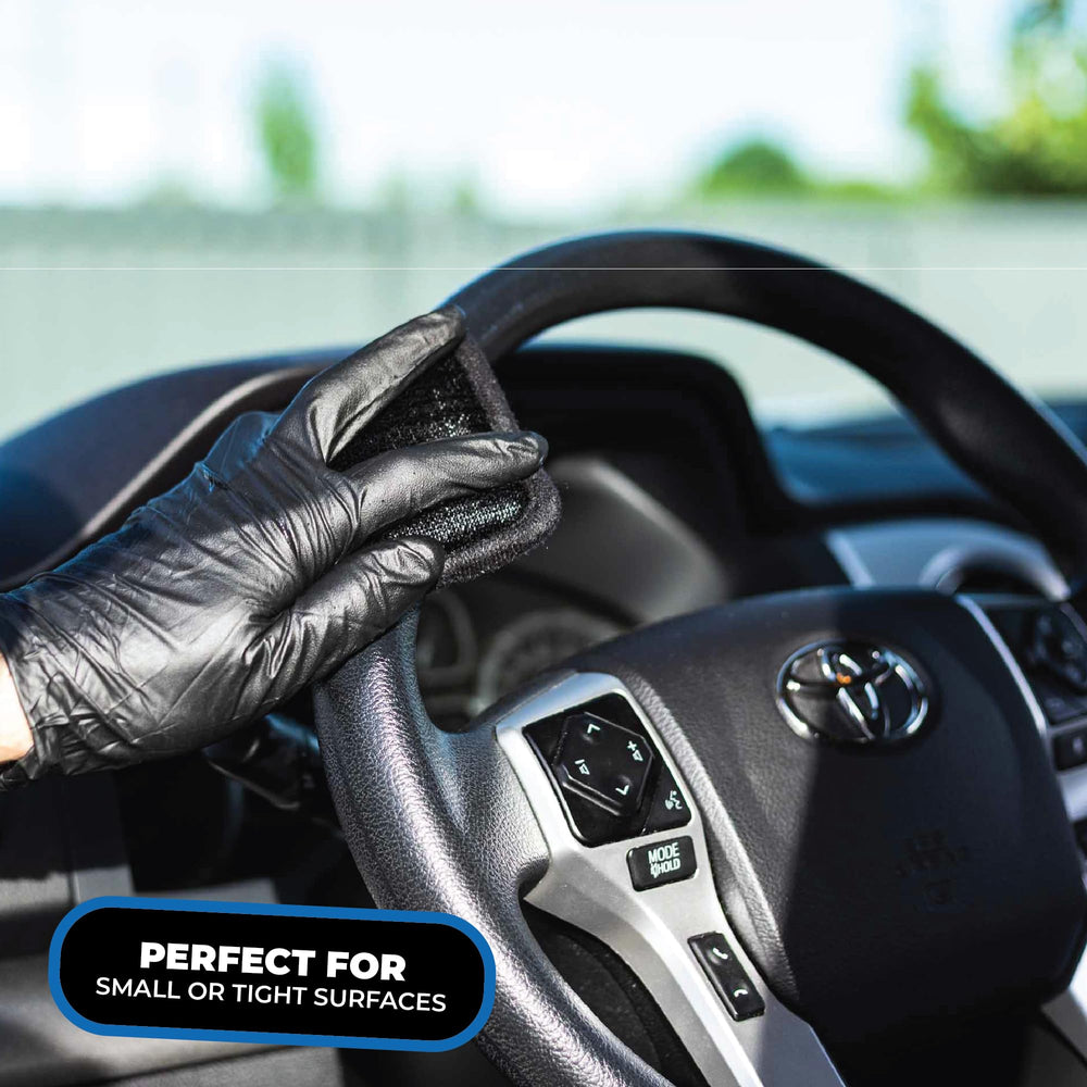 The Rag Company scrubber on an infotainment screen demonstrating safe, smear-free cleaning