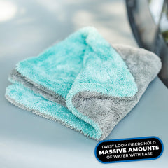 Folded Liquid8r next to a palm hand showing compact 16x16 scale for precise use