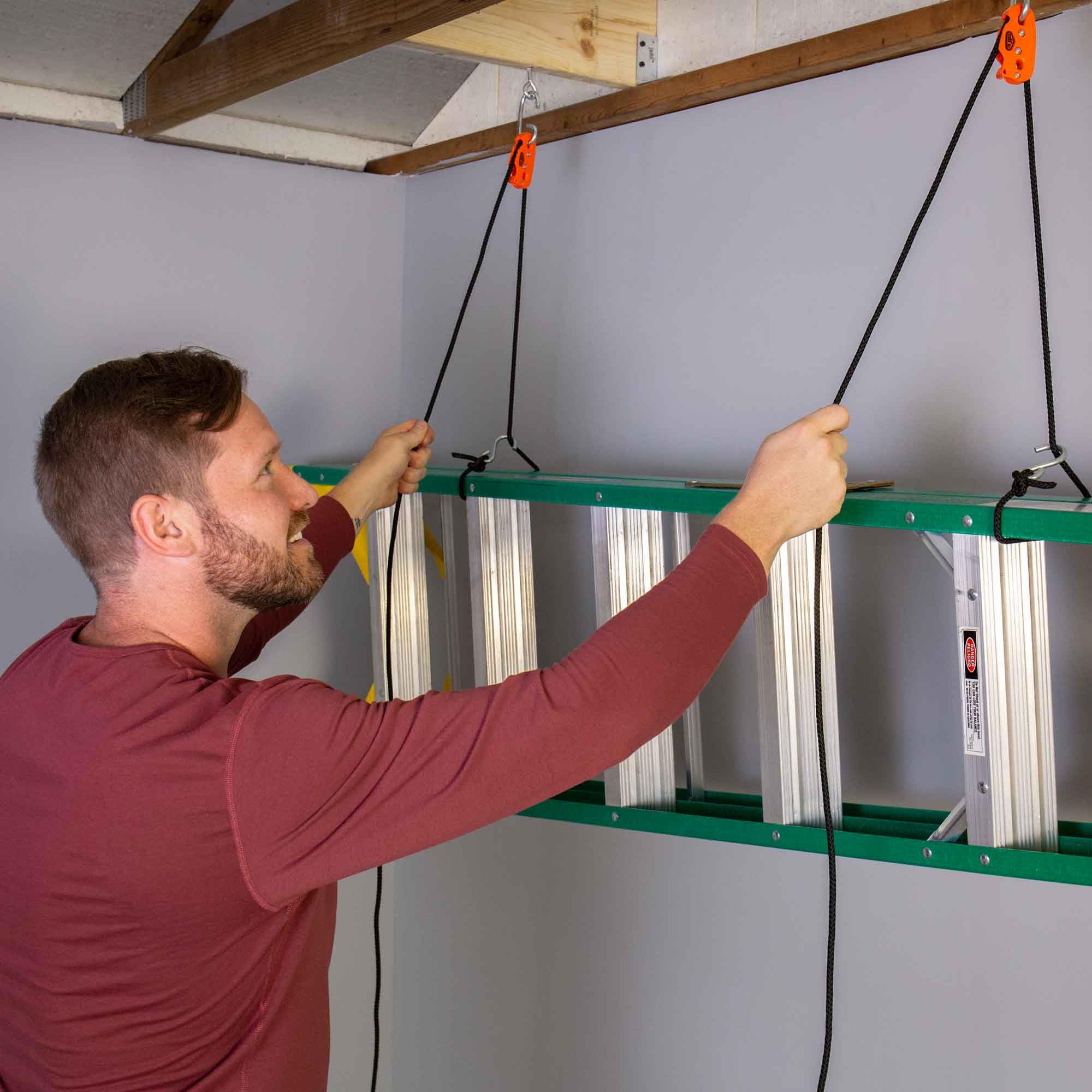 Tie Boss hoisting bicycles in garage illustrating organized storage