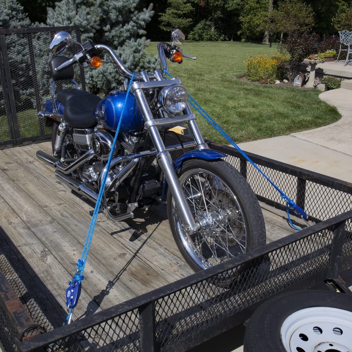 Tie Boss tied to utility trailer rail showing secure cargo restraint in outdoor conditions