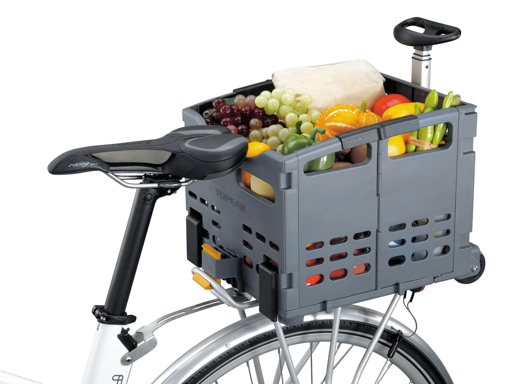 Topeak TrolleyTote carrying groceries beside a bicycle in urban shopping setting
