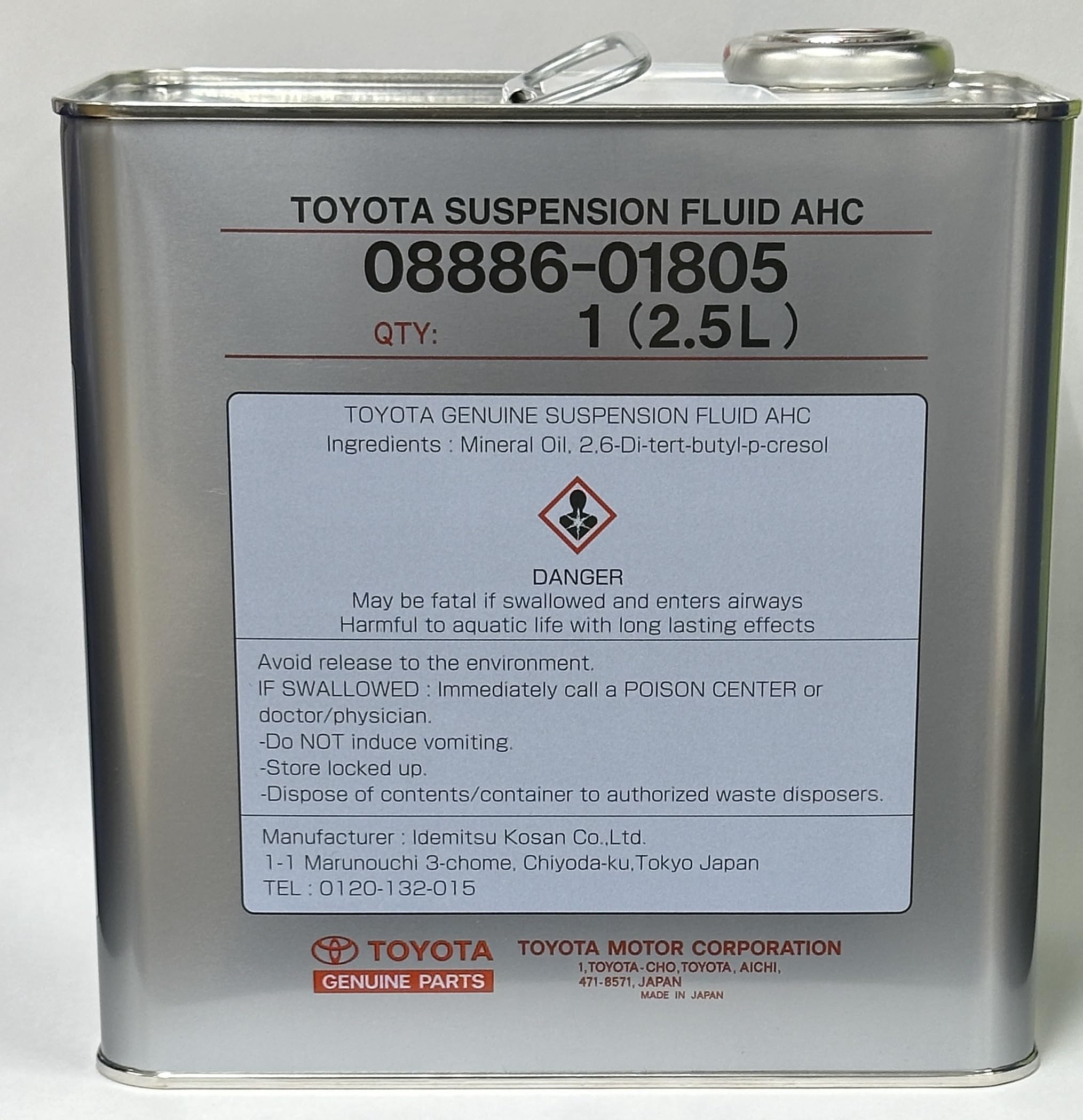Toyota genuine suspension fluid being poured beside a measured container to ensure correct service volume