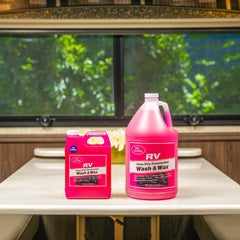 TR gallon bottle next to RV wheel illustrating scale and economical coverage