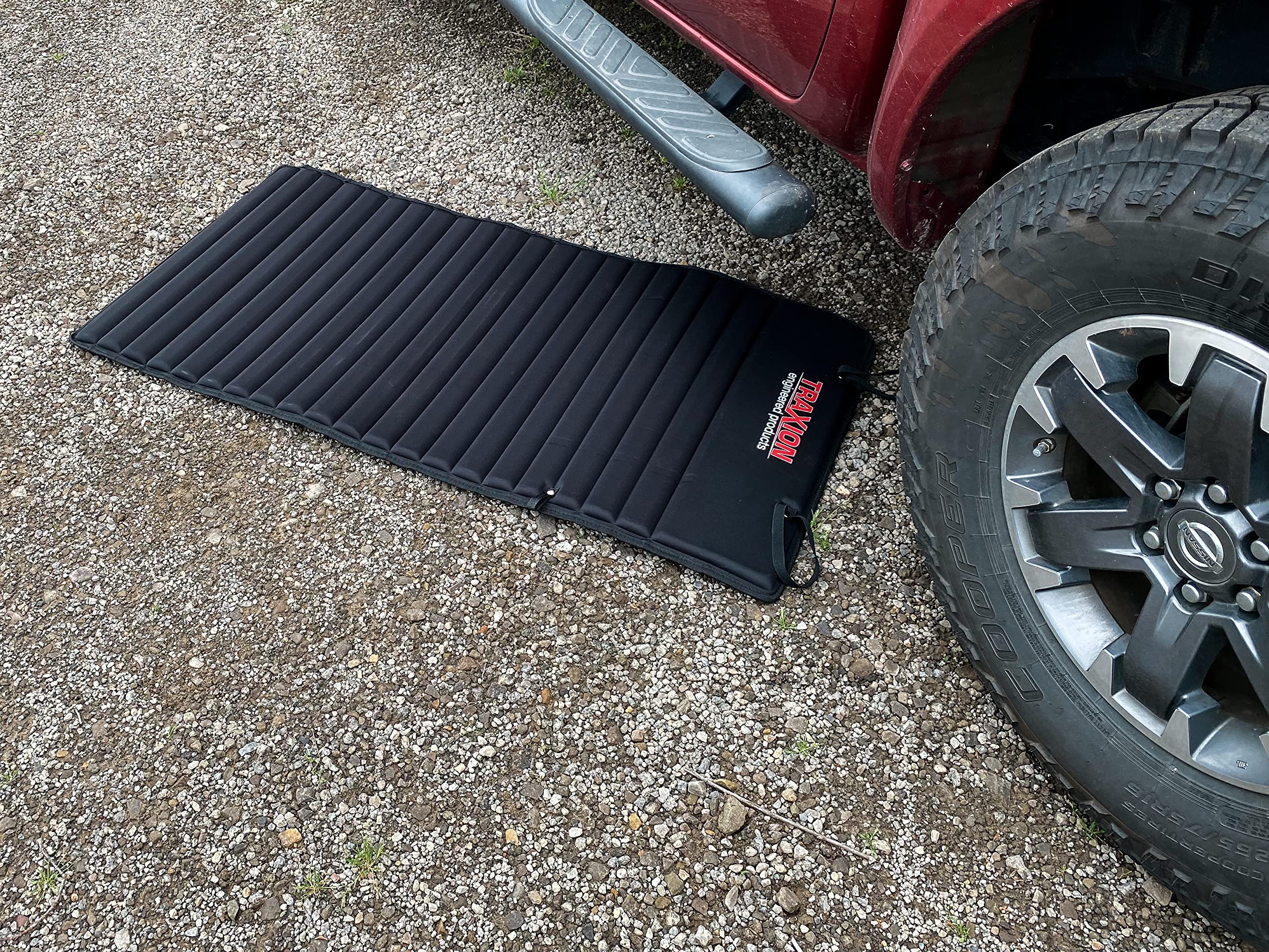Traxion VersaMat placed under car demonstrating protection benefit