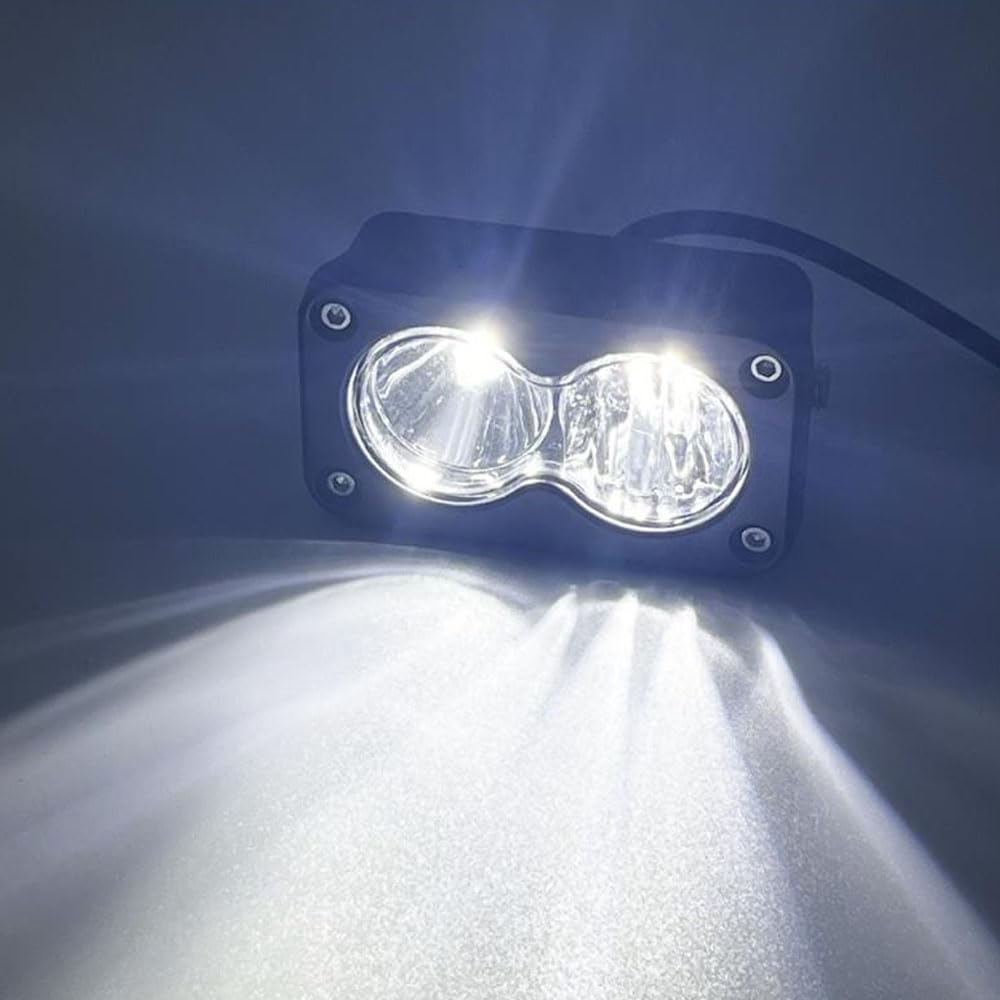 Treayes headlight held beside a hand for scale, shows compact durable size