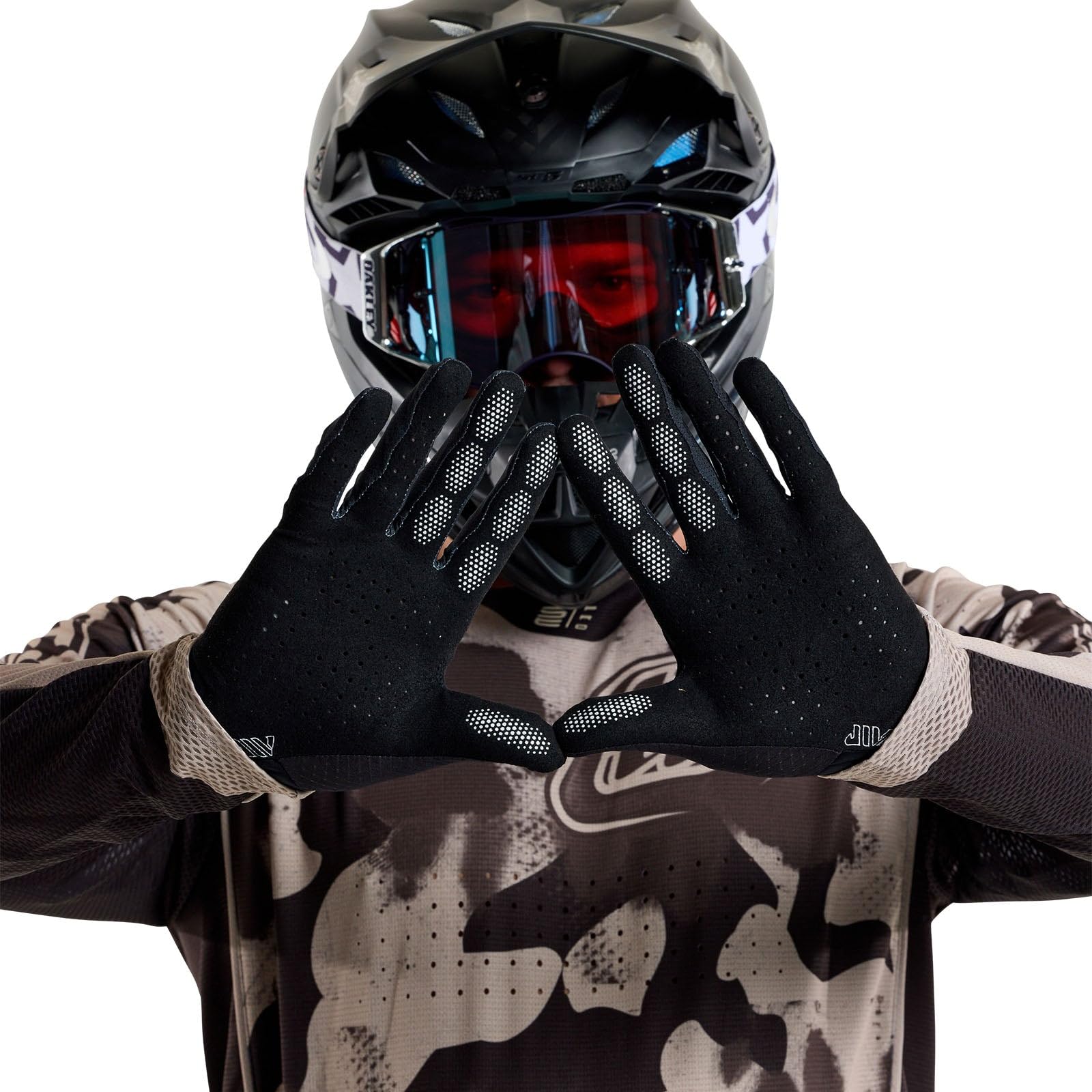 Rider wearing Troy Lee Designs Air Glove using motorcycle handlebar, improving grip and control