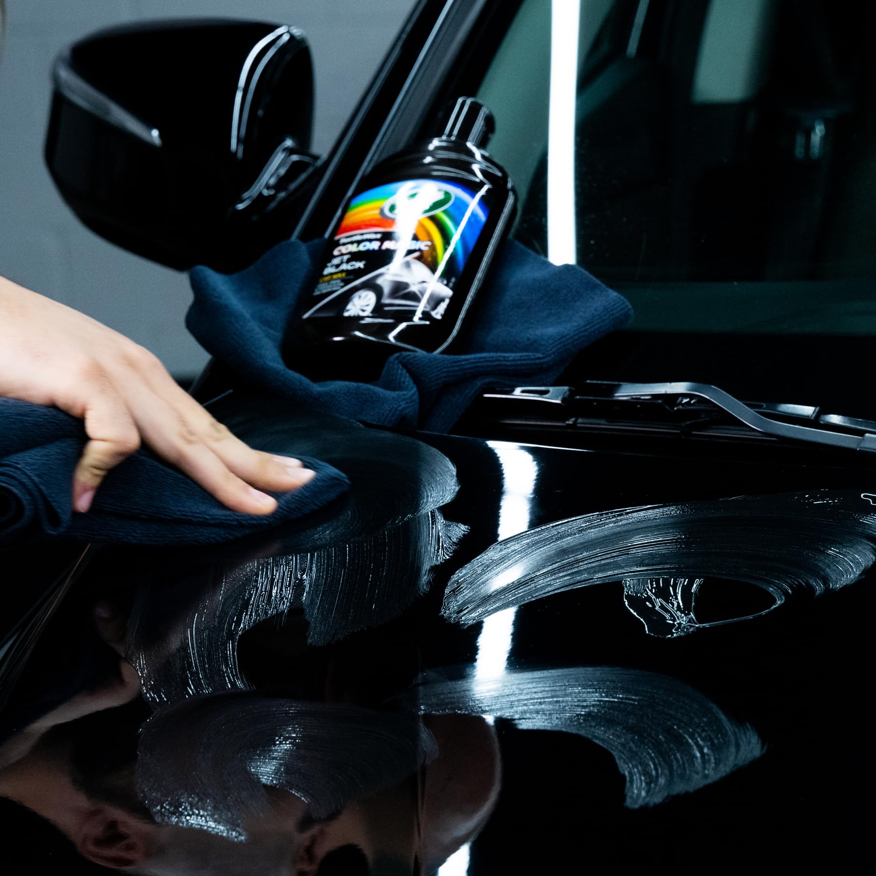 Turtle Wax Color Magic being applied to a car door panel for visible results