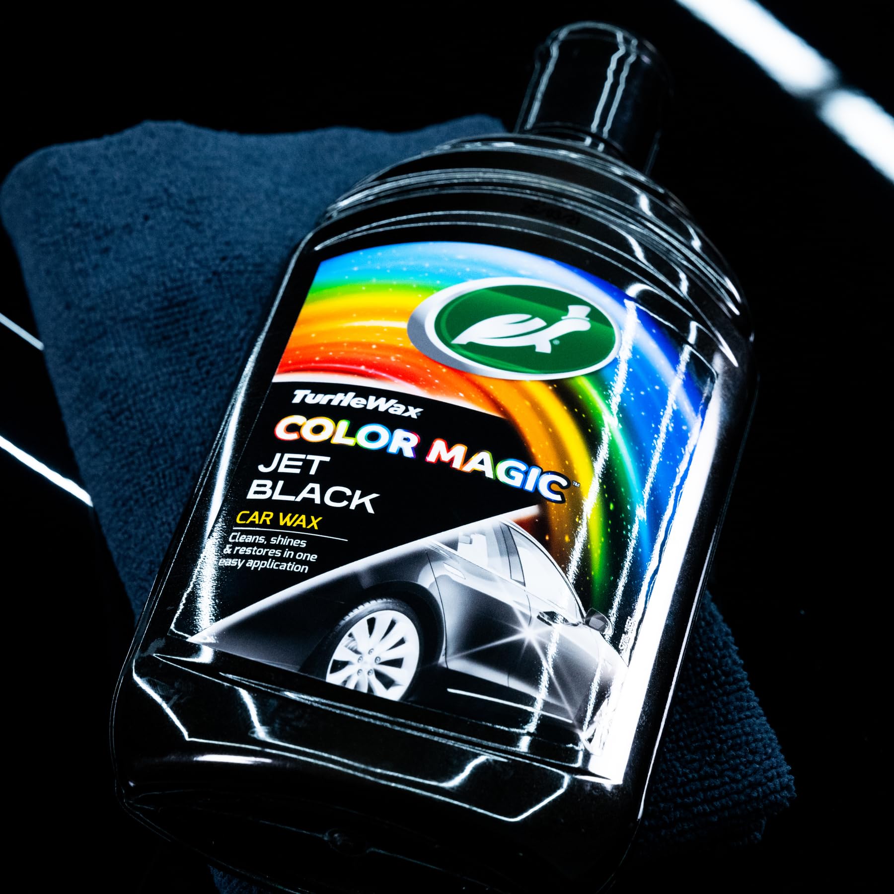 Turtle Wax Color Magic 500ml bottle held in hand to show scale and portability