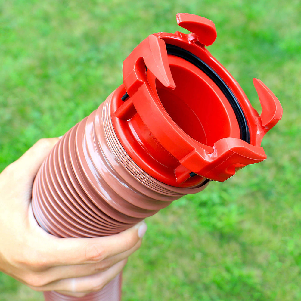 Valterra adapter beside a hand for scale showing small, portable size benefit