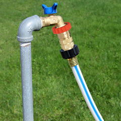 Valterra regulator attached to campground spigot with hose, protecting RV plumbing