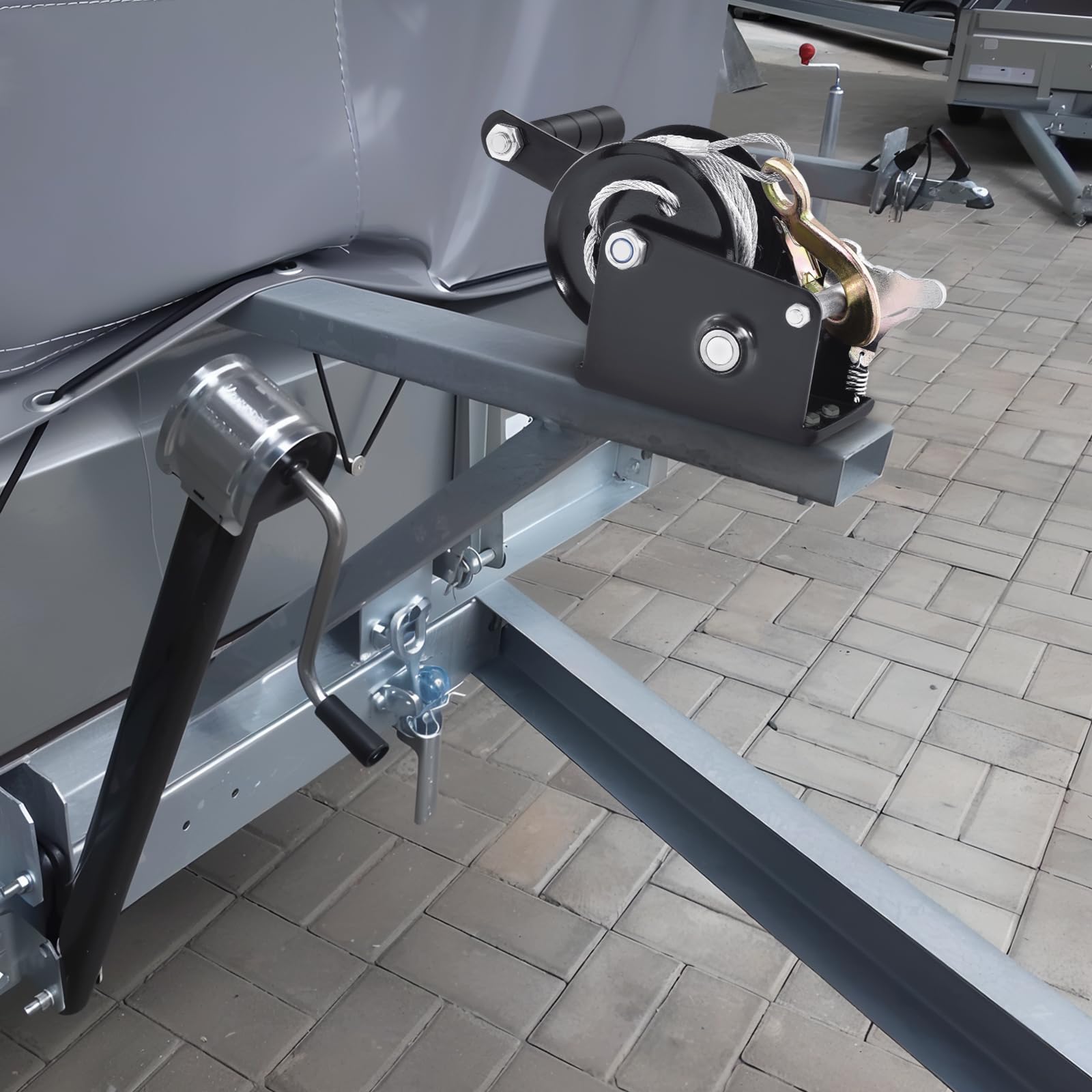 VEVOR hand winch next to tape measure showing compact size and scale