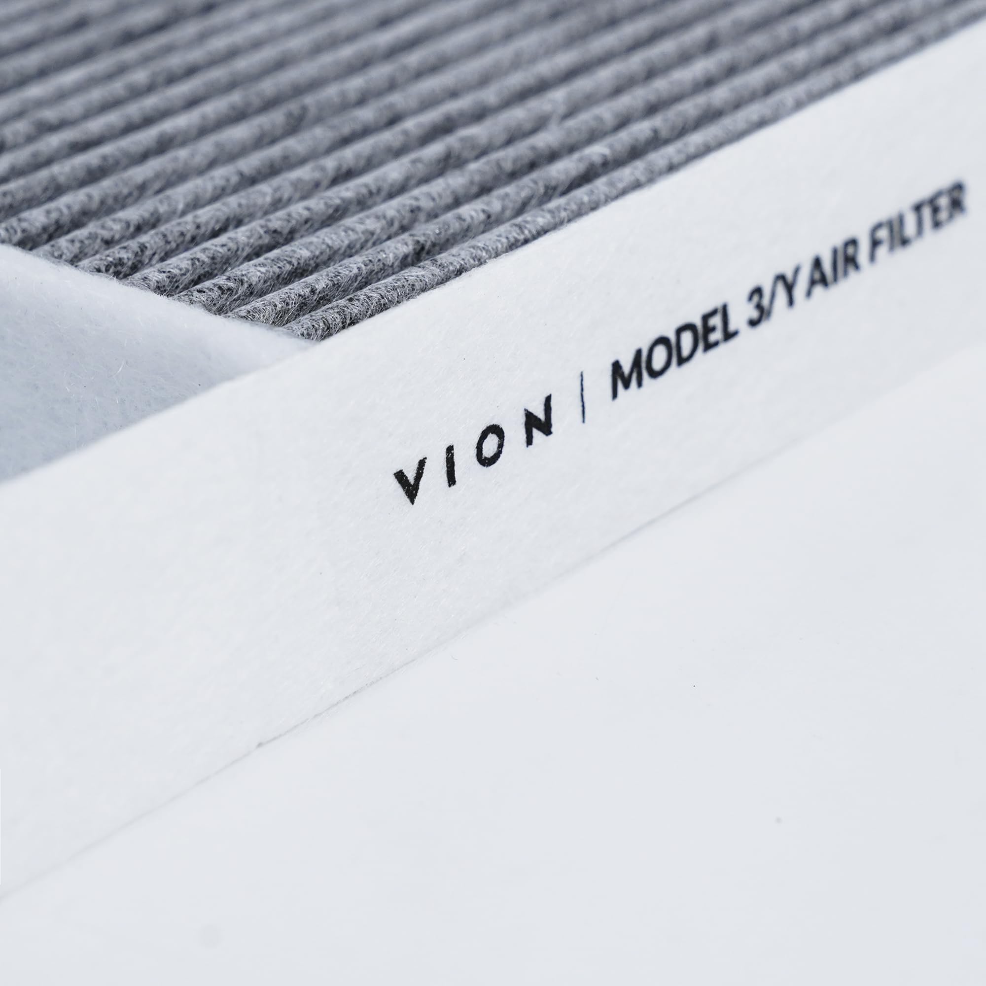 VION filter next to coin for scale showing OEM-compatible size