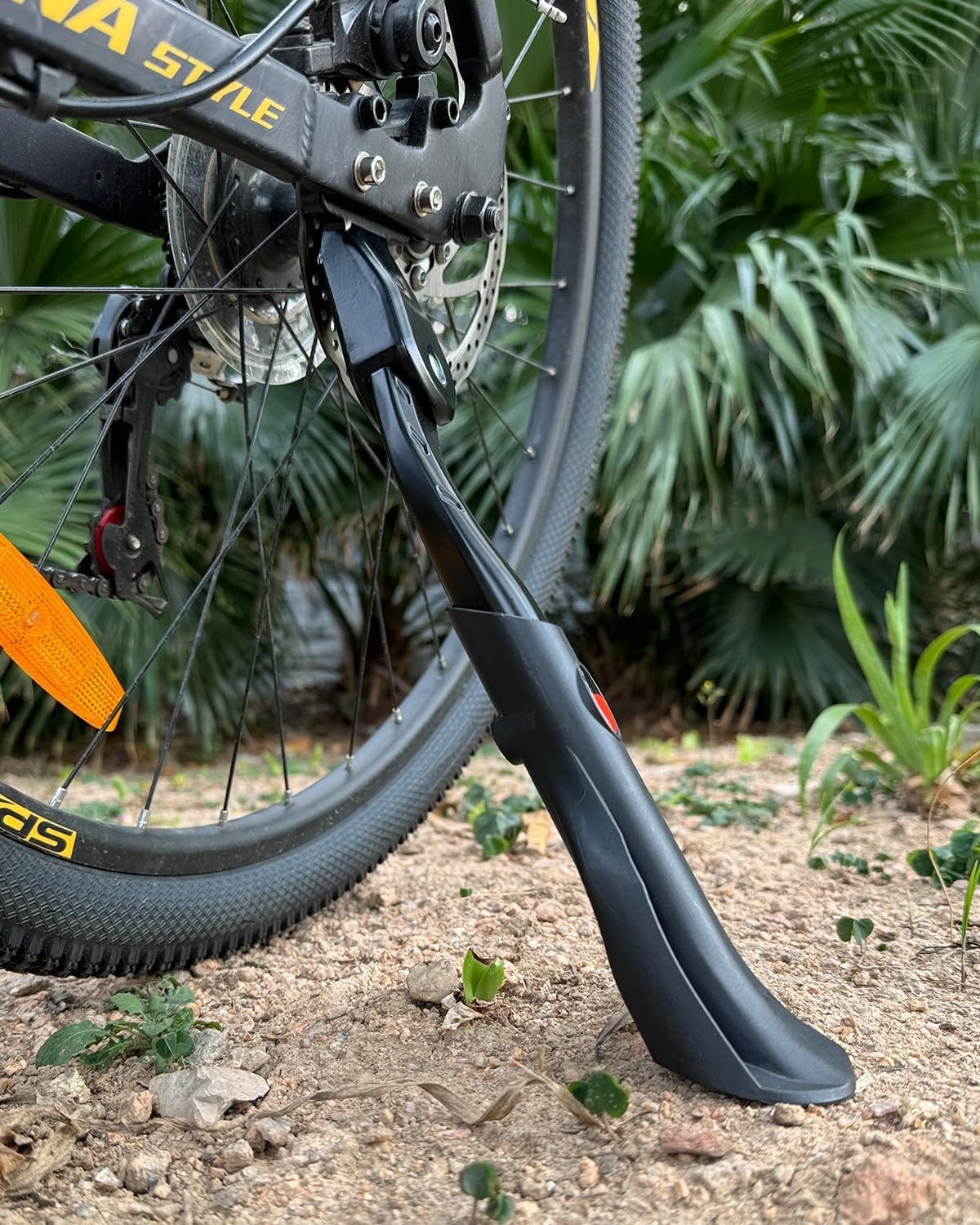 Wakano kickstand supporting bicycle on grass showing improved stability