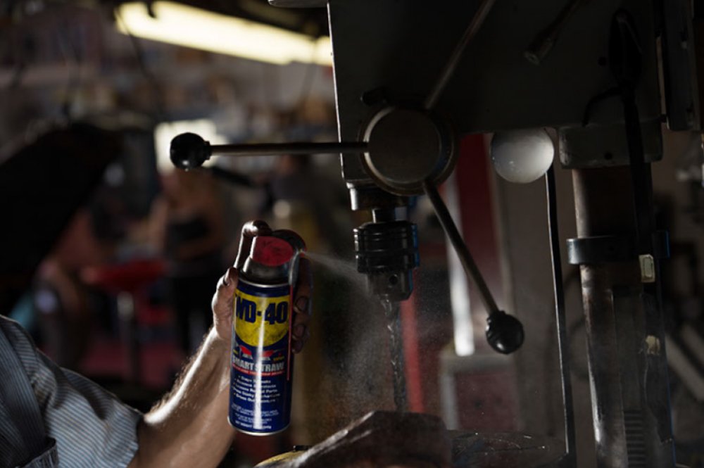 WD-40 on a garage workbench in use during a DIY maintenance task
