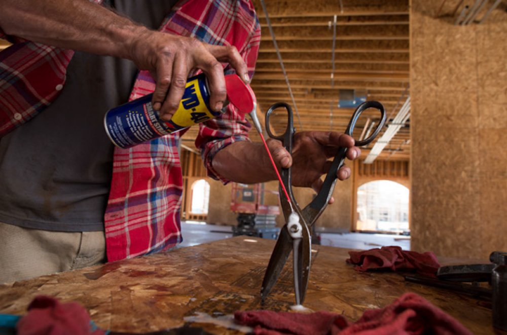 WD-40 11 oz can next to a ruler showing compact size for toolboxes and shelves