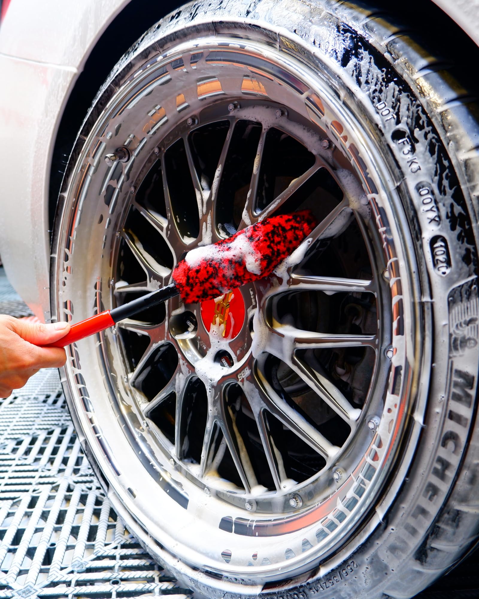 brand brushes in use on car wheel illustrating scratch-free deep cleaning