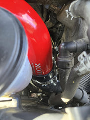Xotic Performance stainless steel spring-loaded T-bolt clamp closeup showing secure, temperature-adaptive clamp