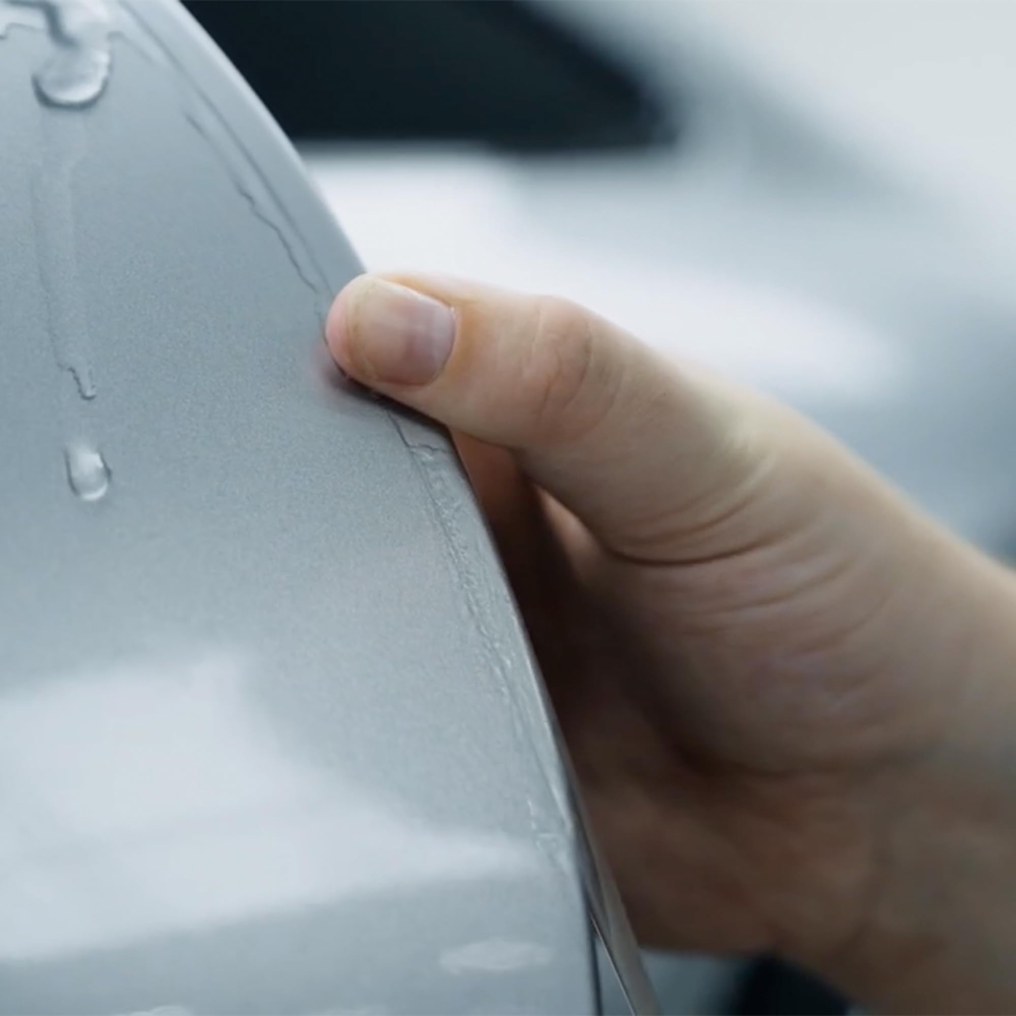 XPEL on parked car door showing protection in tight urban parking situations