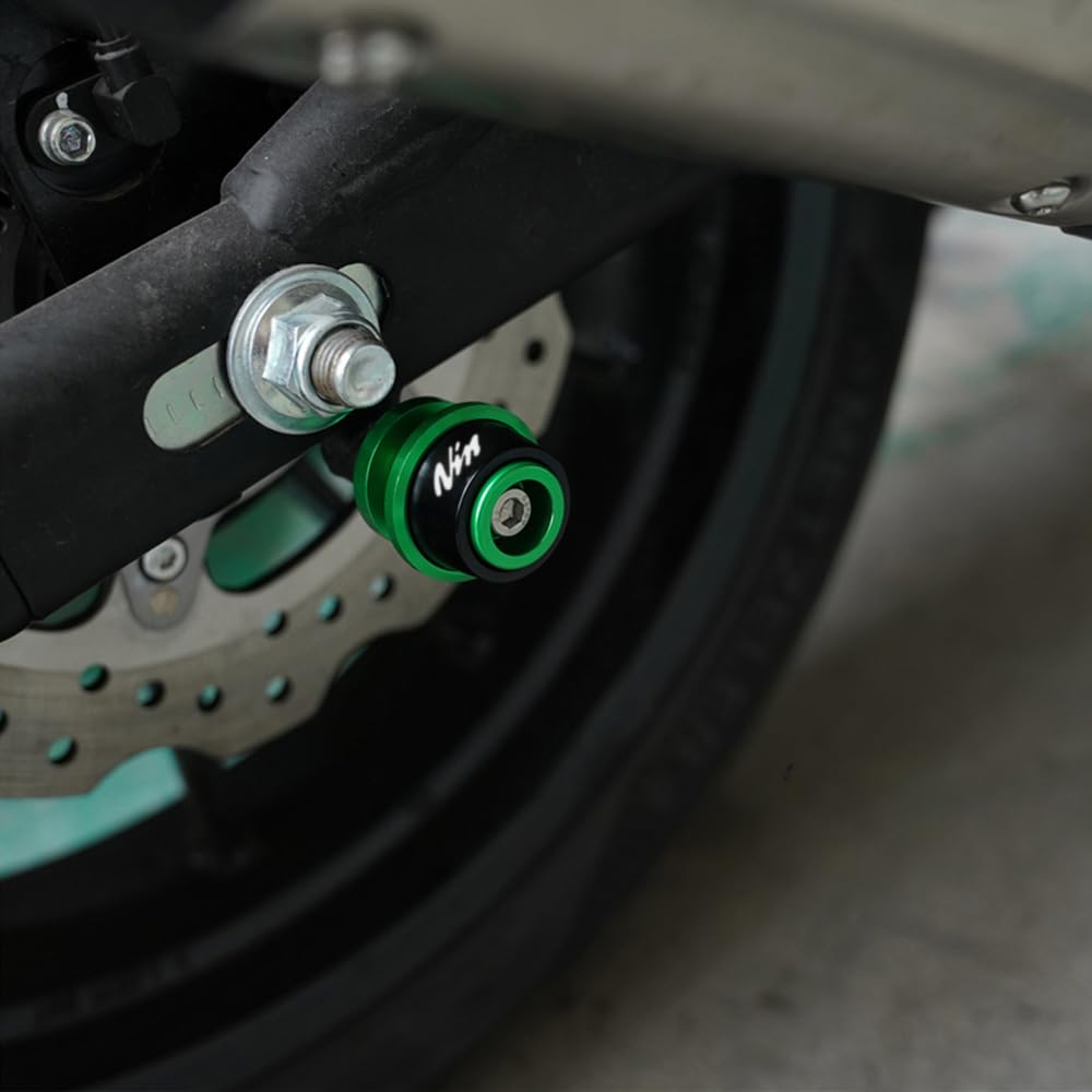 ZYAKOMO spool installed on swingarm showing stable paddock stand contact